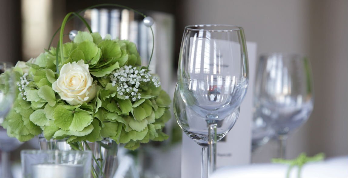 Detailaufnahme eines gedeckten Hochzeitstisches mit Weingläsern und Blumen in der Hochzeitslocation im 5 Sterne Hotel Grand Elysée in Hamburg